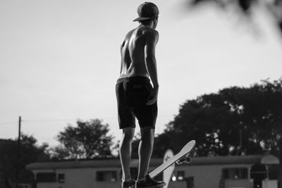 Skaters  low angle of man standing clear sky