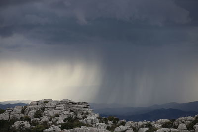 Scenic view of storm cloud over mountains against sky