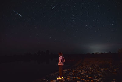 The girl on the shore is sad. raise your head to see a shooting star and make a wish. dream on. 