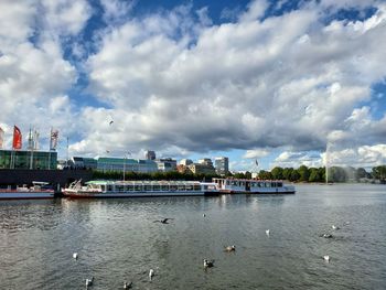 Bridge over river against sky in city