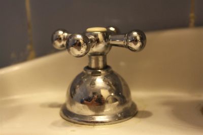 Close-up of faucet in bathroom