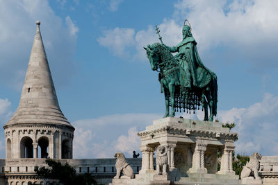 Low angle view of statue against cloudy sky