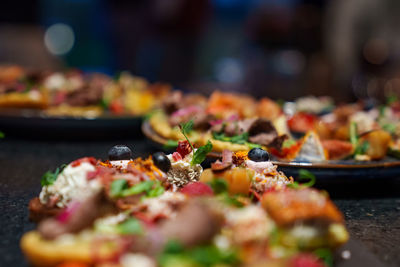 Set of beautiful canapes on black stone plates. buffet table. catering.