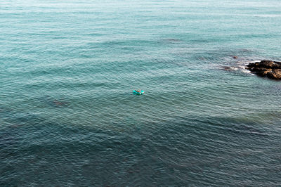 Lonely couple on a float in the middle of the sea on a summer day.