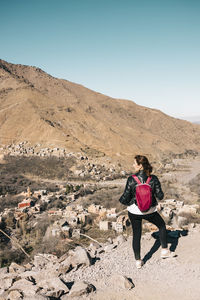 Full length of woman on arid landscape against clear sky