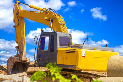 Yellow construction site against sky