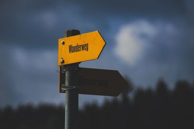 Road sign against sky