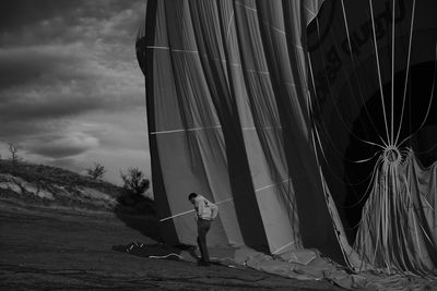 Man standing by hot air balloon