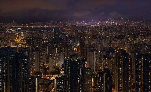 Illuminated cityscape against sky at night