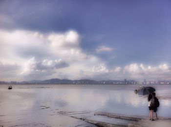 Full length of woman on beach against sky