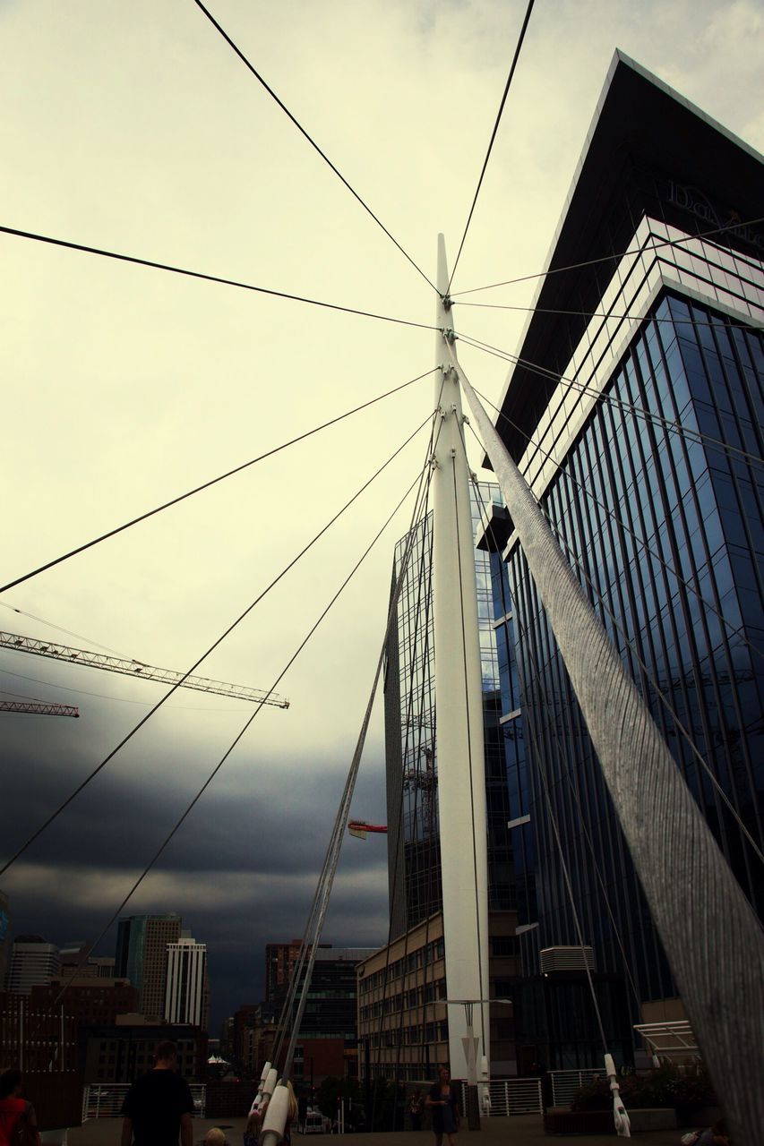 architecture, built structure, building exterior, sky, low angle view, cable, city, cloud - sky, building, residential structure, power line, day, residential building, outdoors, connection, house, roof, no people, cloud, cloudy