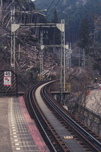 Railroad track against forest