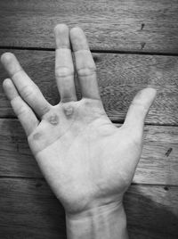 Close-up of hands on wood