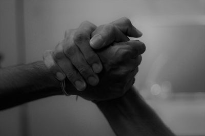 Cropped image of couple holding hands