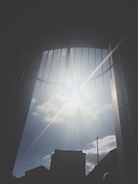 Low angle view of sun shining through window