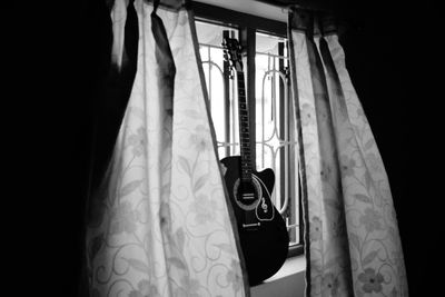 Close-up of clothes hanging on window at home