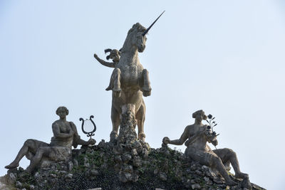 Low angle view of statue against sky