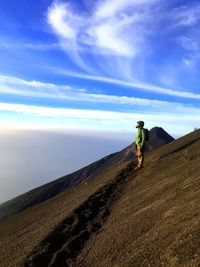 Man standing on mountain against sky