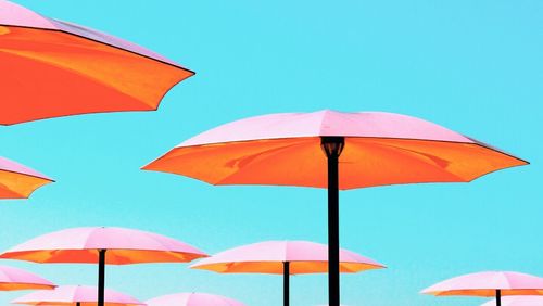 Umbrella on beach umbrellas against clear blue sky
