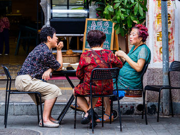 Young couple sitting outdoors