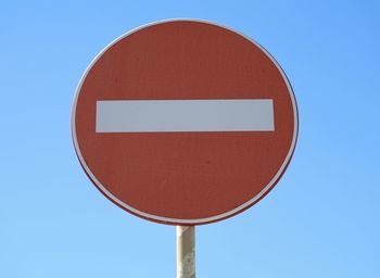 Low angle view of do not enter sign against clear blue sky