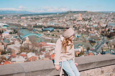 High angle view of woman looking at cityscape