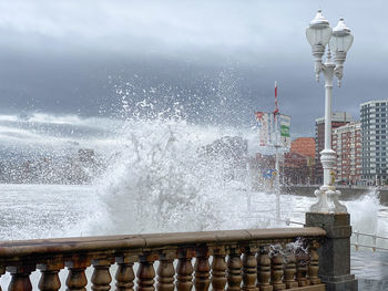 Water splashing in fountain against sea