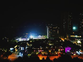 High angle view of illuminated buildings against sky at night