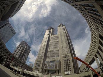 Low angle view of buildings against cloudy sky