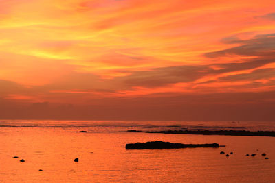 Scenic view of sea against romantic sky at sunset