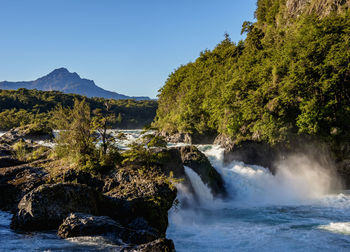 Scenic view of waterfall against clear sky