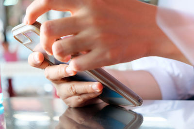 Midsection of man using mobile phone