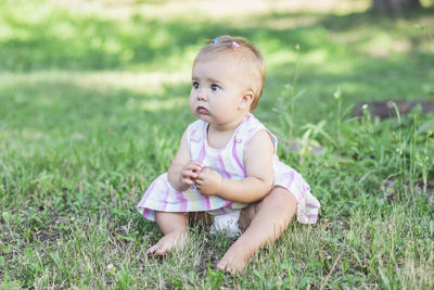 Portrait of cute baby boy on field