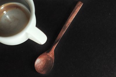 Directly above shot of coffee cup against black background