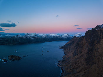 Scenic view of snowcapped mountains against sky during sunset