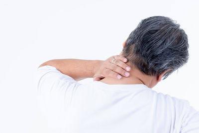 Rear view of man touching white background