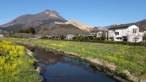 Stream against mountains in village