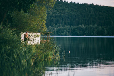 Man fishing on lakeshore