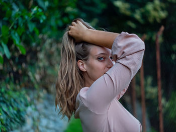 Portrait of a young woman standing outdoors