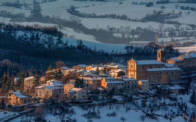 Aerial view of snow covered houses at sunset