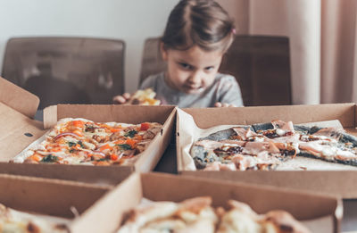 Cute girl looking at pizza