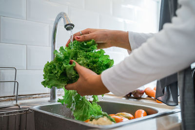 Midsection of man preparing food in kitchen