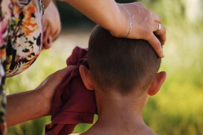 Close-up of mother and son outdoors