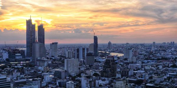 Aerial view of city buildings during sunset