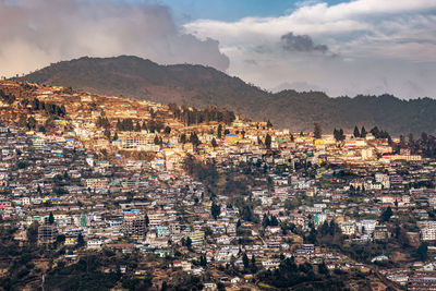 City urbanization view from hilltop with huge construction and dramatic sky