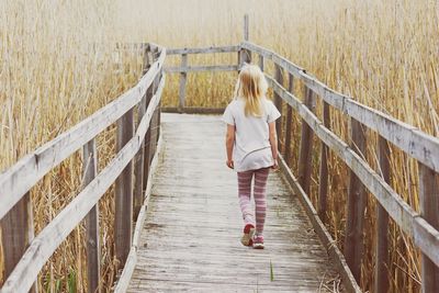 Woman walking on footbridge