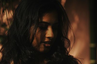 Close-up of thoughtful young woman with black hair