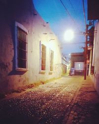 Street amidst buildings in city at night