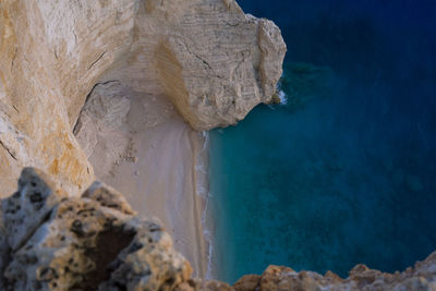 Close-up of rock formation in sea against sky