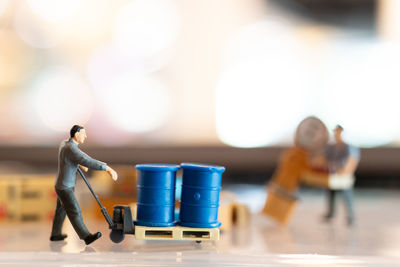 Close-up of people at figurine